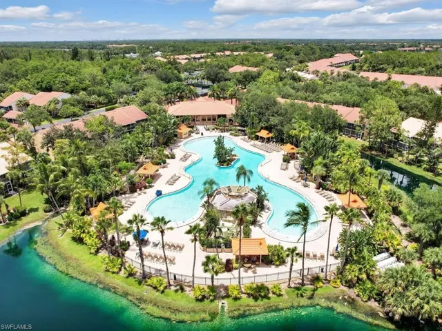 Birds eye view of property with a water view