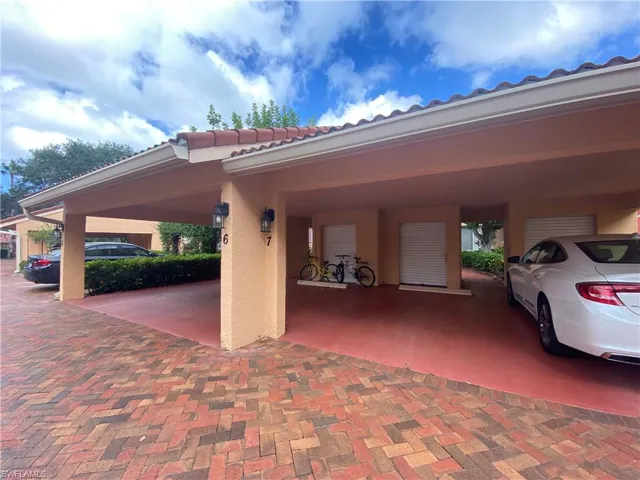 View of parking featuring a carport