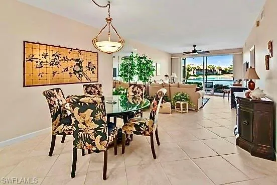 Dining room with ceiling fan and light tile patterned flooring