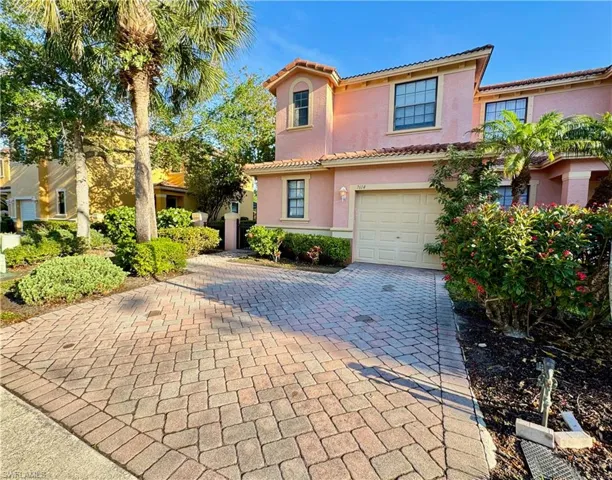 Mediterranean / spanish home featuring stucco siding, an attached garage, a tile roof, and decorative driveway