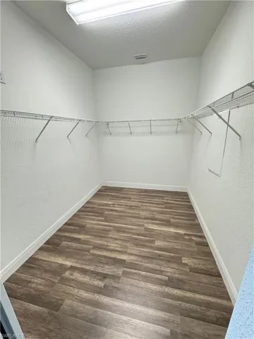 Walk in closet featuring wood finished floors