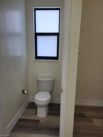 Bathroom with wood finished floors and toilet