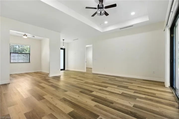 Unfurnished bedroom with wood finished floors and ensuite bath