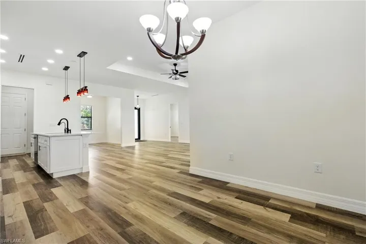 Full bath featuring a freestanding tub, a walk in shower, and wood finished floors