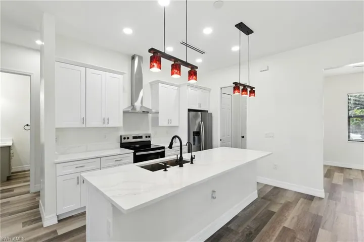Unfurnished living room with light wood-style floors, a chandelier, recessed lighting, and a ceiling fan