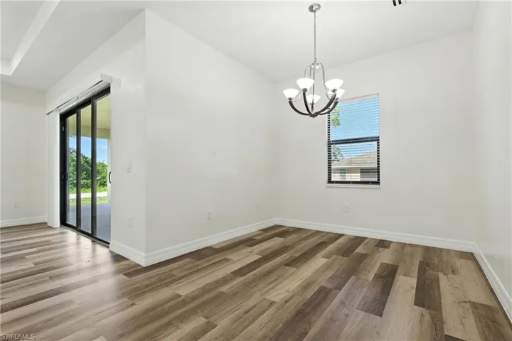 Full bath with healthy amount of natural light, a shower stall, a soaking tub, and light wood-style floors