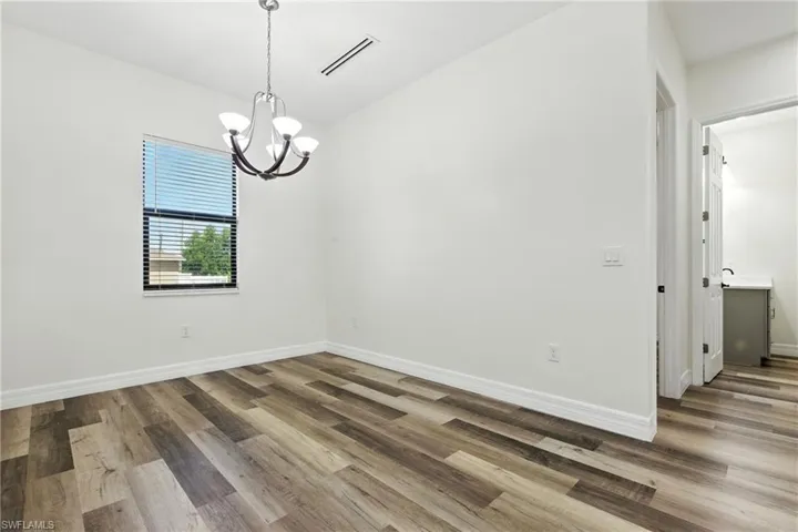 Full bathroom with dark wood-style flooring, recessed lighting, and a closet