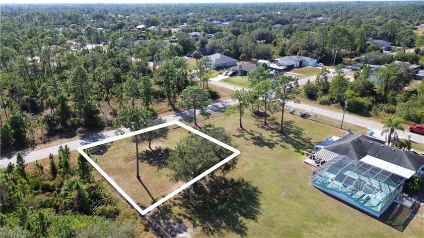 Aerial view of residential area featuring a heavily wooded area