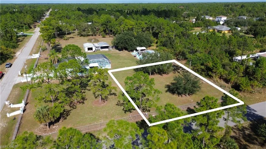 View of property location featuring property boundaries highlighted and a forest