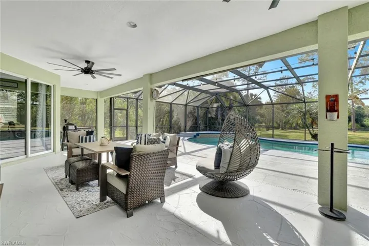 View of patio with glass enclosure and ceiling fan