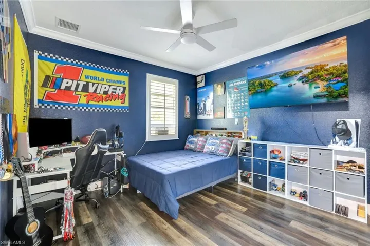Bedroom #3 with crown molding, hardwood / wood-style floors, and ceiling fan