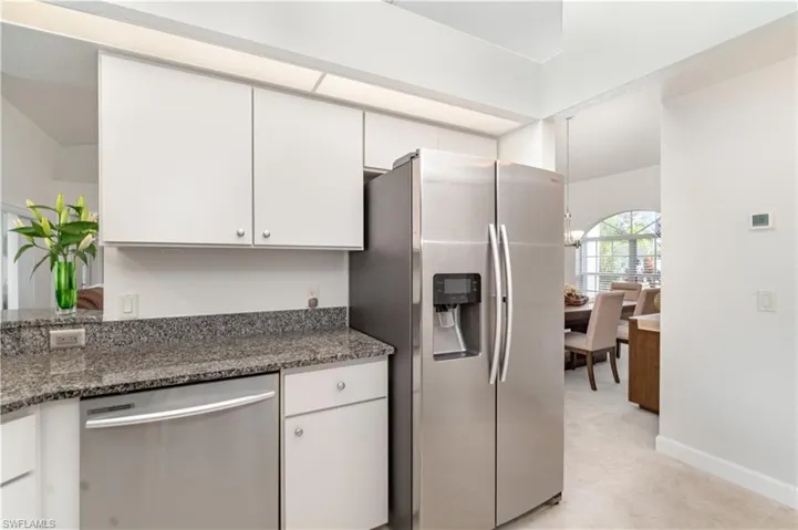 Kitchen with stainless steel appliances, dark stone countertops