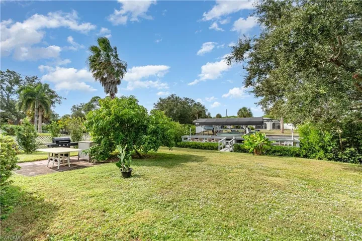 View of green lawn with a patio