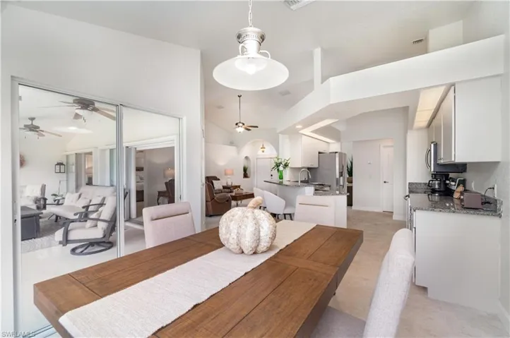 Dining room with a ceiling fan and baseboards