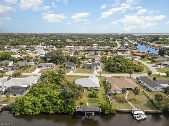 Aerial view of residential area featuring a nearby body of water