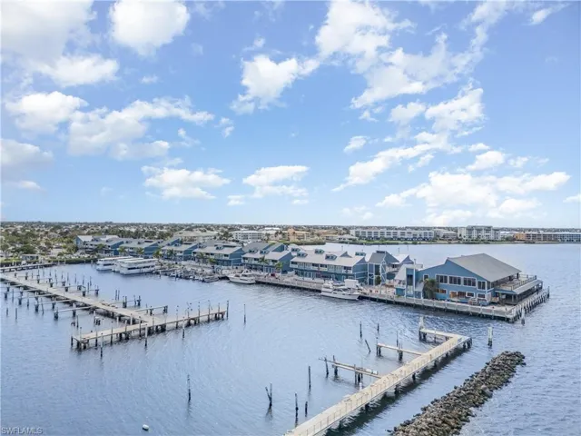 Dock featuring view of marina and a water view
