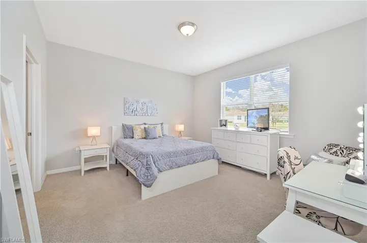 Carpeted bedroom featuring baseboards