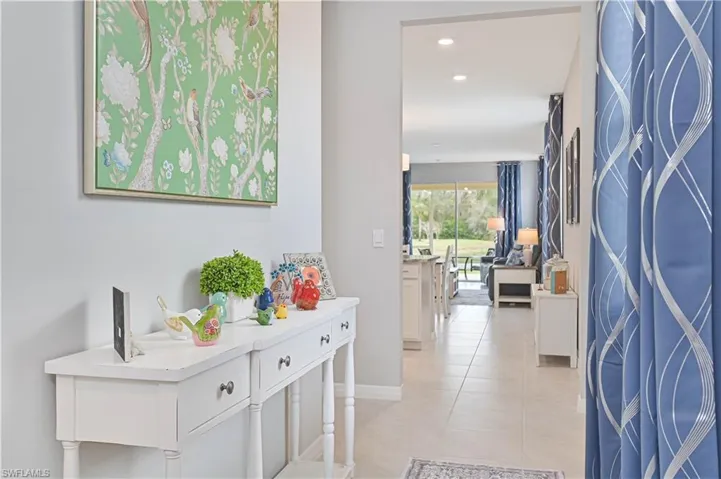 Hallway featuring recessed lighting and light tile patterned floors