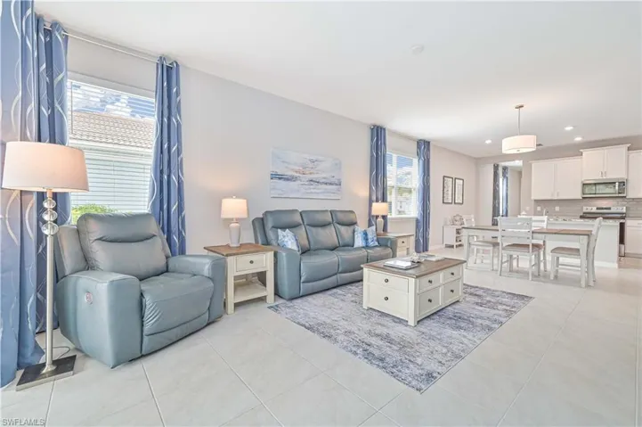 Living area featuring light tile patterned floors and recessed lighting