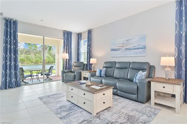 Living room featuring a water view and light tile patterned flooring