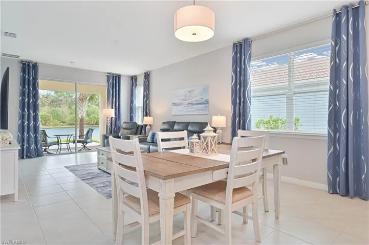 Dining space featuring healthy amount of natural light and light tile patterned floors