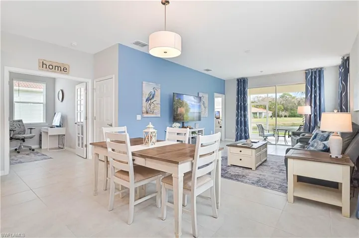 Dining room featuring light tile patterned floors and an office area