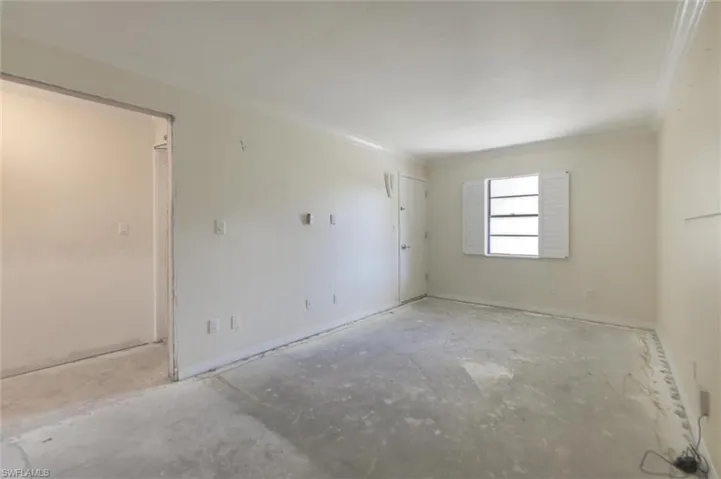 Empty room featuring ornamental molding