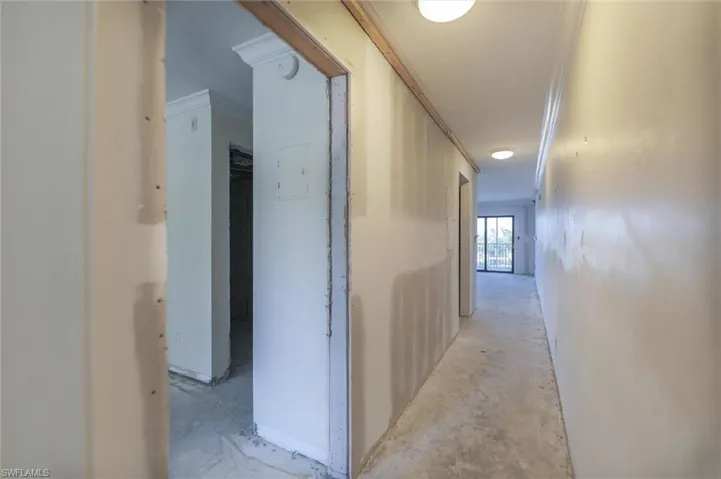 Corridor featuring crown molding