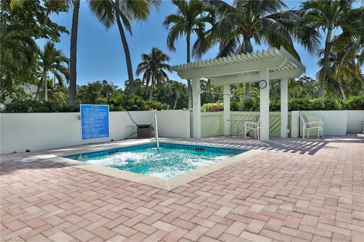 View of pool with a patio area, a pergola, and a hot tub