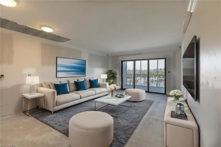 Living room featuring concrete floors and crown molding