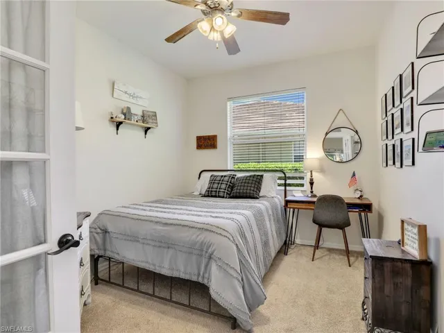 Carpeted bedroom featuring baseboards and a ceiling fan