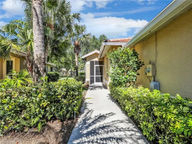 Property entrance with a tiled roof and stucco siding