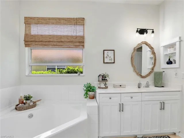 Full bathroom featuring vanity and a bath