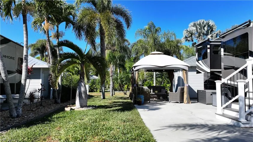 View of green lawn featuring a gazebo and a patio area