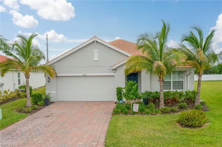 Single story home with a front yard and a garage