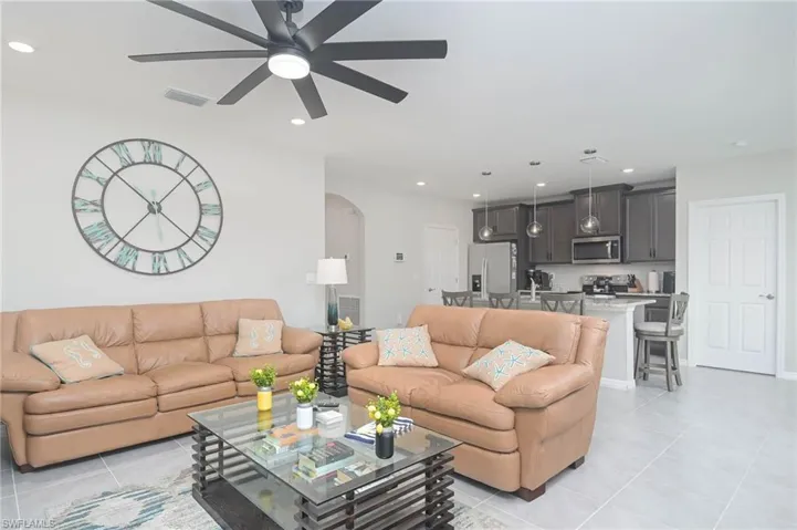 Living room featuring ceiling fan and light tile patterned floors