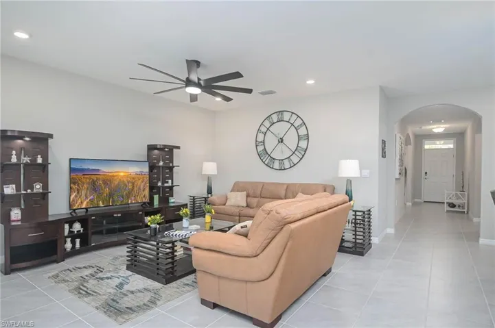 Living room featuring ceiling fan and light tile patterned floors