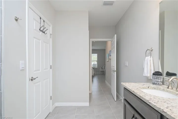 Bathroom with tile patterned flooring and vanity