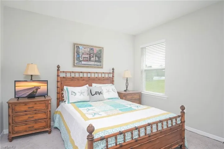Bedroom featuring light colored carpet