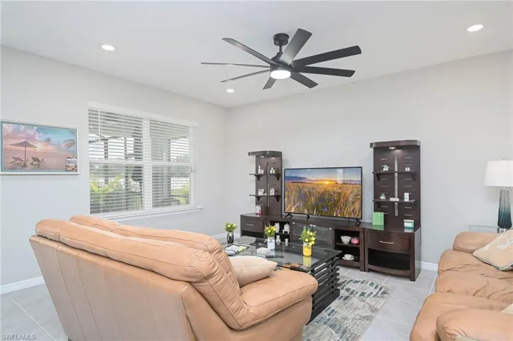 Tiled living room featuring ceiling fan