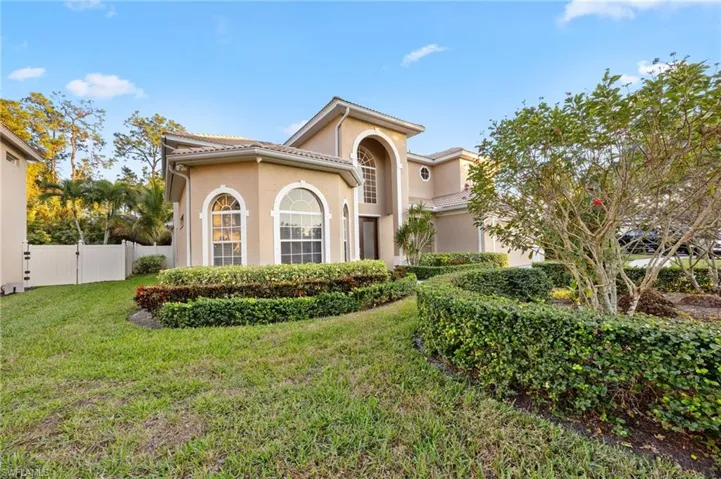 Mediterranean / spanish home with stucco siding and a gate
