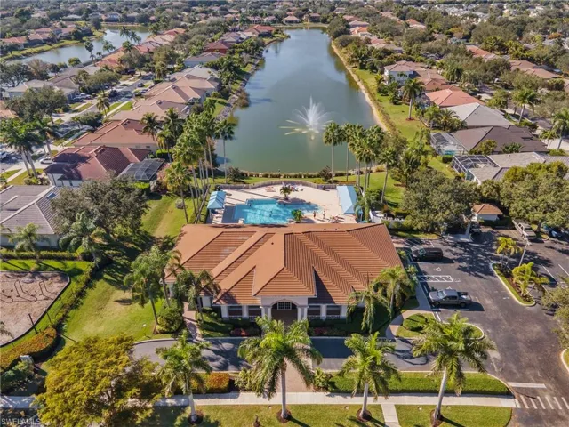 Aerial view of property's location featuring a nearby body of water and nearby suburban area