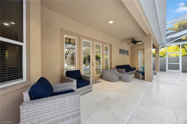 View of patio with outdoor lounge area, a ceiling fan, a sunroom, and glass enclosure