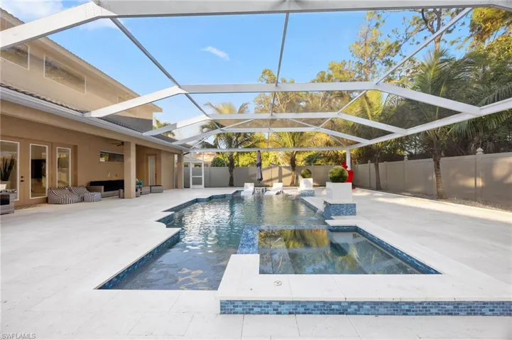 View of pool with a sunroom, a fenced backyard, a patio, glass enclosure, and an outdoor hangout area