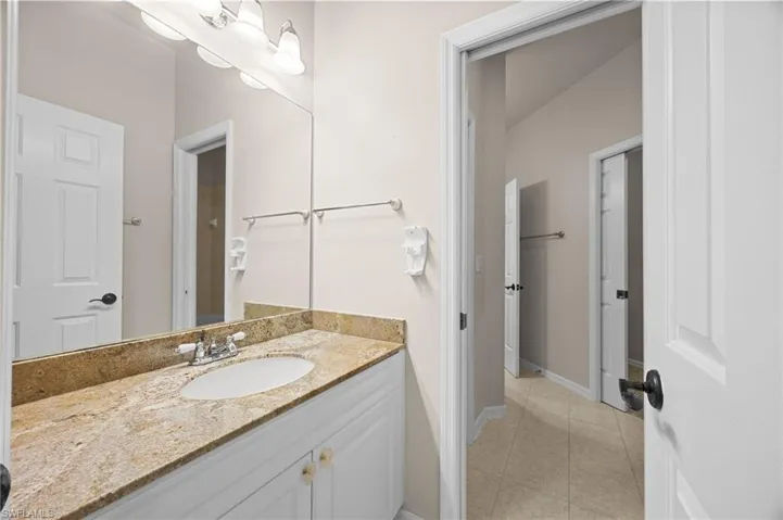 Bathroom with vanity and light tile patterned floors