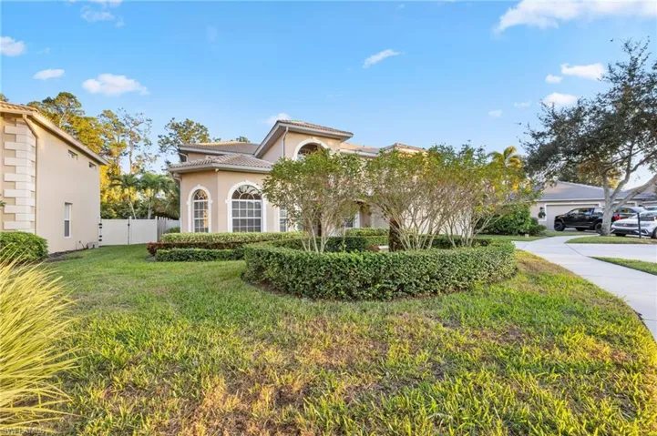 Mediterranean / spanish home featuring stucco siding, a gate, and a tile roof