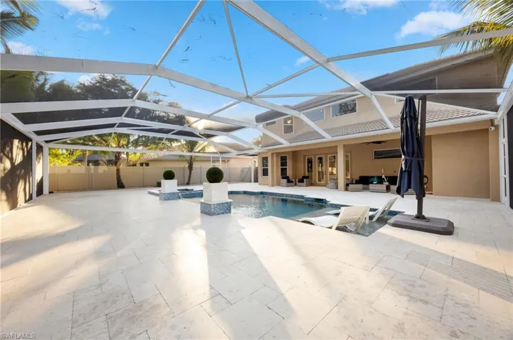 View of swimming pool featuring a sunroom, a patio, a lanai, an outdoor living space, and a pool with connected hot tub