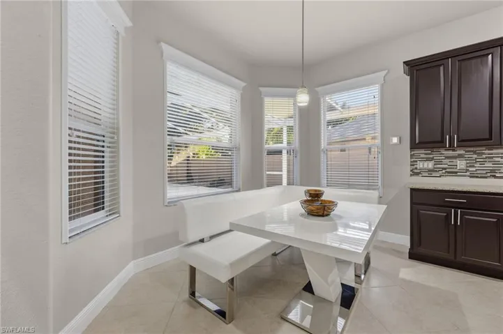 Dining space with breakfast area and light tile patterned floors