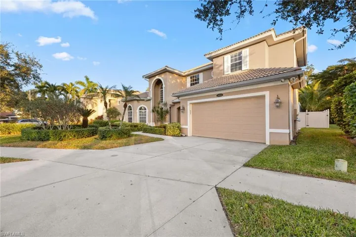 Mediterranean / spanish house with driveway, a garage, a gate, and stucco siding