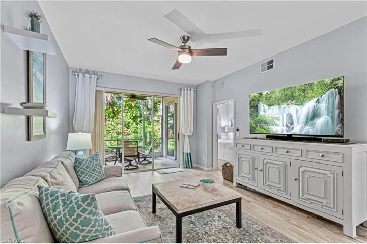Living room featuring ceiling fan and light hardwood / wood-style floors